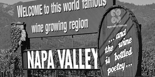 Welcome to Napa Valley sign featuring the bottled poetry slogan