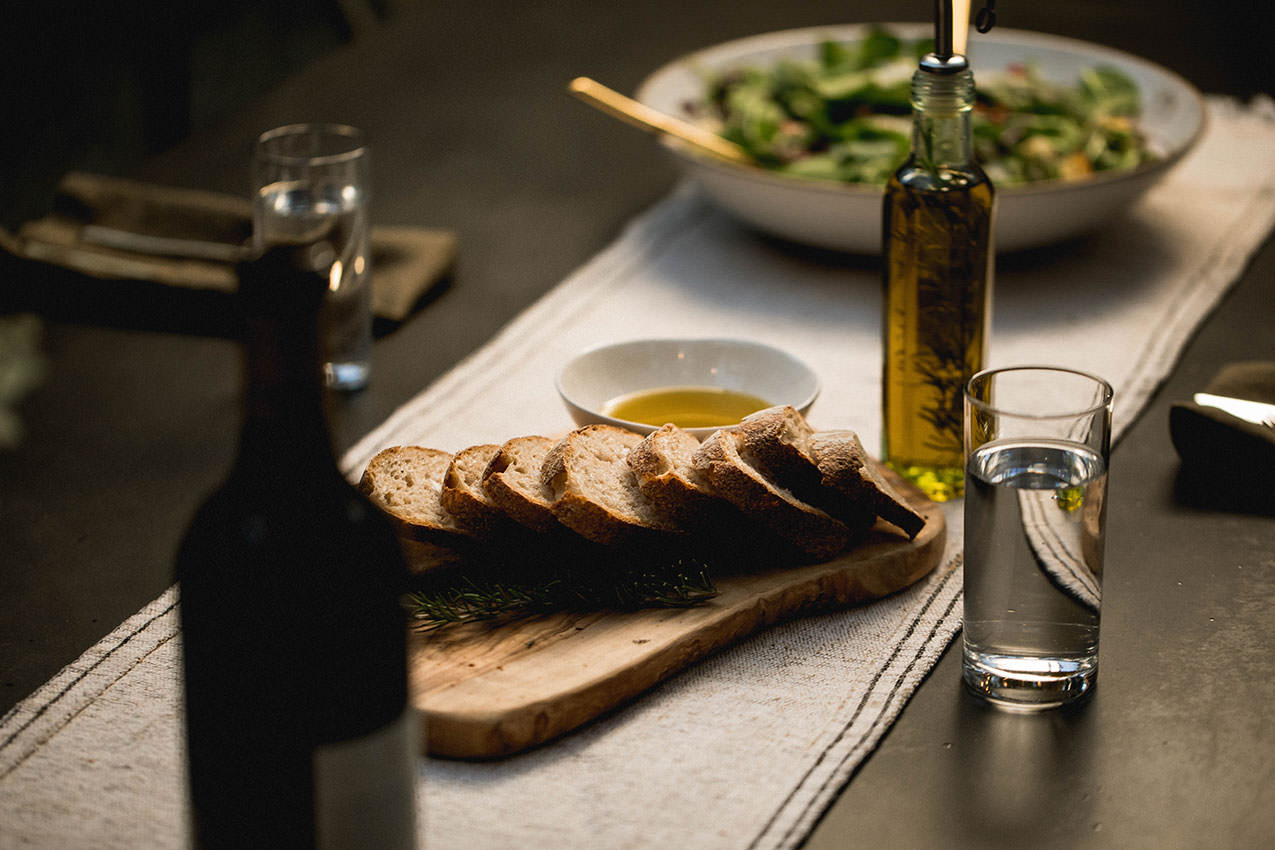 a salad and bread set on a dinner table