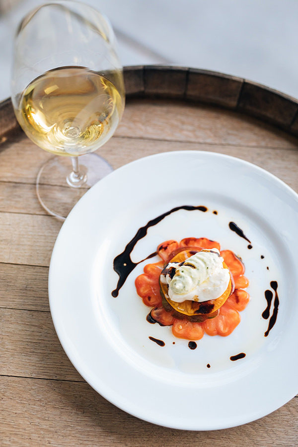 white wine in a glass paired with a plated dessert