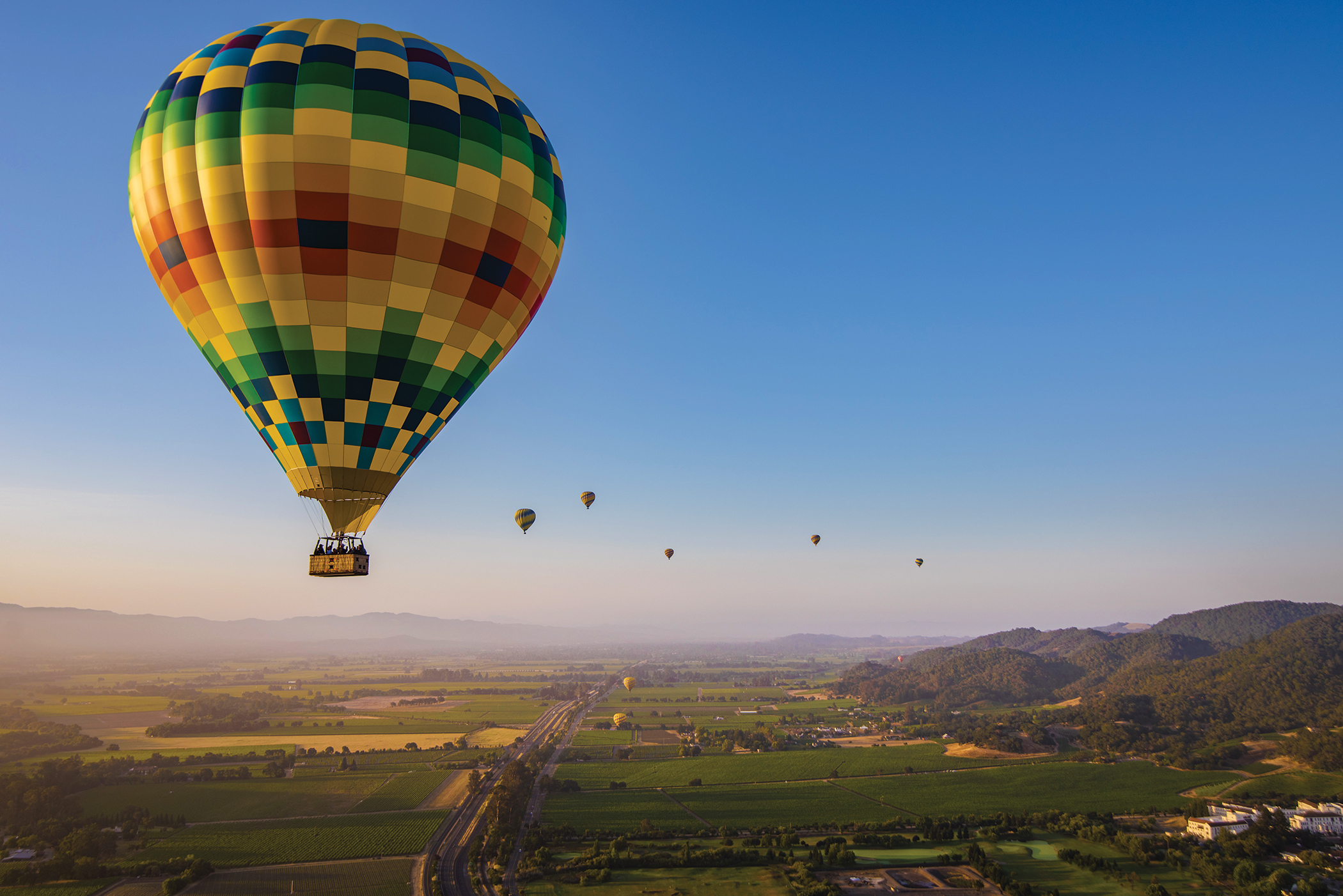 hot air balloons float over Napa Valley