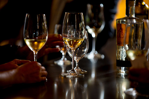 two glasses of white wine in a bar setting