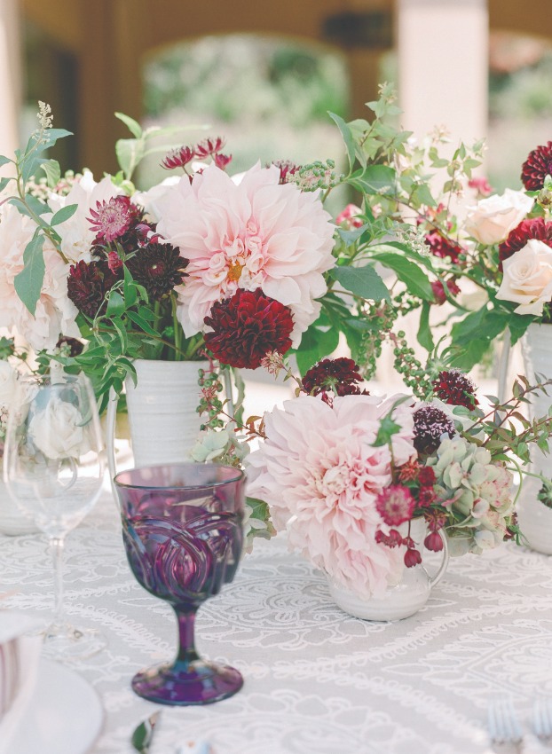 pink and red flower arrangements with purple glass
